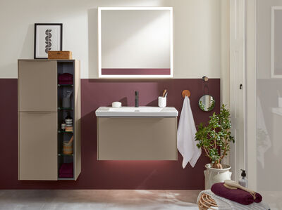 © Villeroy & Boch Beige Badmöbel und ein Einzelwaschbecken aus weißer Keramik vor einer Wand, die zur Hälfte in einem Beerenton gestrichen ist