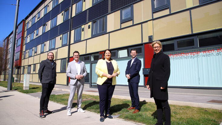 © PID/VOTAVA Wiener Wohnen Direktorin Karin Ramser, wohnfonds_wien Geschäftsführer Gregor Puscher, Vizebürgermeisterin Kathrin Gaal, Umweltstadtrat Jürgen Czernohorszky und Bezirksvorsteher Stv Penzing Markus Loos (v.r.n.l.) vor der gedämmten Glasfassade des Gemeindebaus.