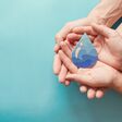 Adult and child hands holding paper cut water drop, World Water Day, Clean water and sanitation, CSR, save water, ecology concept