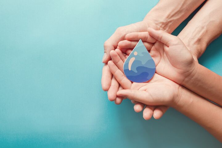 Adult and child hands holding paper cut water drop, World Water Day, Clean water and sanitation, CSR, save water, ecology concept