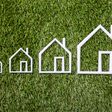 Outline Of An Increasing Size Of House On Green Grass