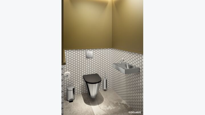Toilette mit Handwaschbecken daneben.