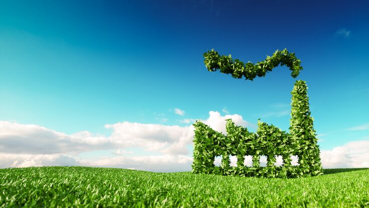 Eco friendly industry concept. 3d rendering of green factory icon on fresh spring meadow with blue sky in background.