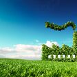 Eco friendly industry concept. 3d rendering of green factory icon on fresh spring meadow with blue sky in background.