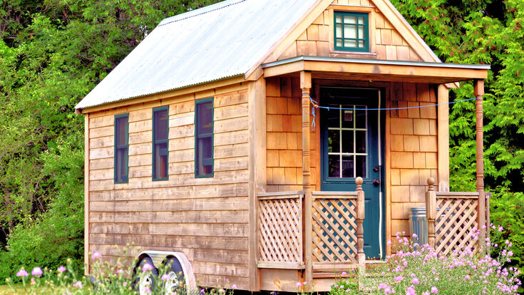 © lowphoto - stock.adobe.com house tiny green freedom micro building small little architecture porch millennials estate home cottage door modern exterior front country real rural sale single summer television windows wood wooden view grass