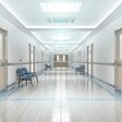 Long hospital bright corridor with rooms and blue seats 3D rendering