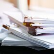 Stack of papers documents in archives files with clip papers on table at offices, Busy offices and Pile of data unfinished folders on office desk indoor near window, Business concept.