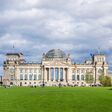 Berlin, Germany - September 9, 2015: People enjoying a warm autumn day on the lawn in front of the Reichstag, German Parliament.